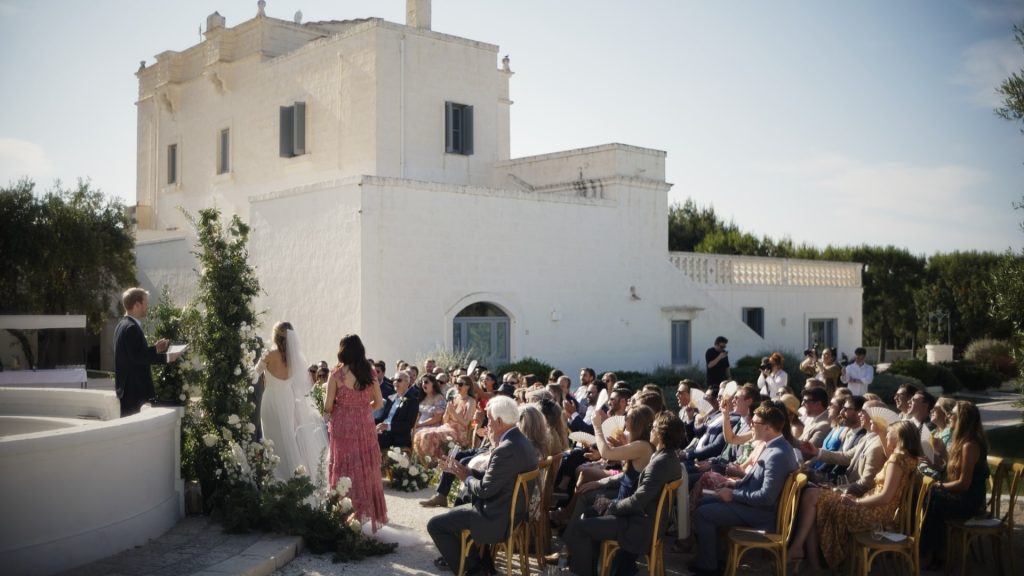 symbolic ceremony during a destination wedding at Masseria San Giovanni Puglia. The couple with all the guests seated