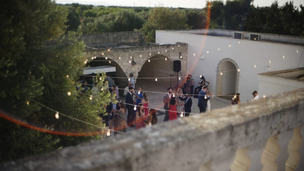 cocktail party in the courtyard of the Masseria among the Puglia olive groves during the destination wedding of Mike and Alex
