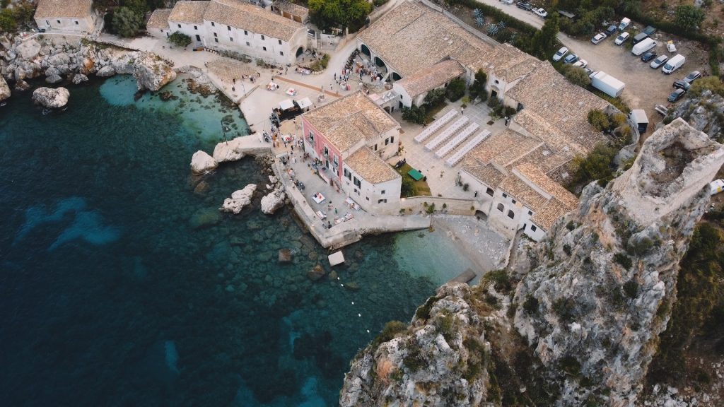 panoramic view of the Tonnara di Scopello along the rocky coast and turquoise sea of Castellamare del Golfo Siciliy
