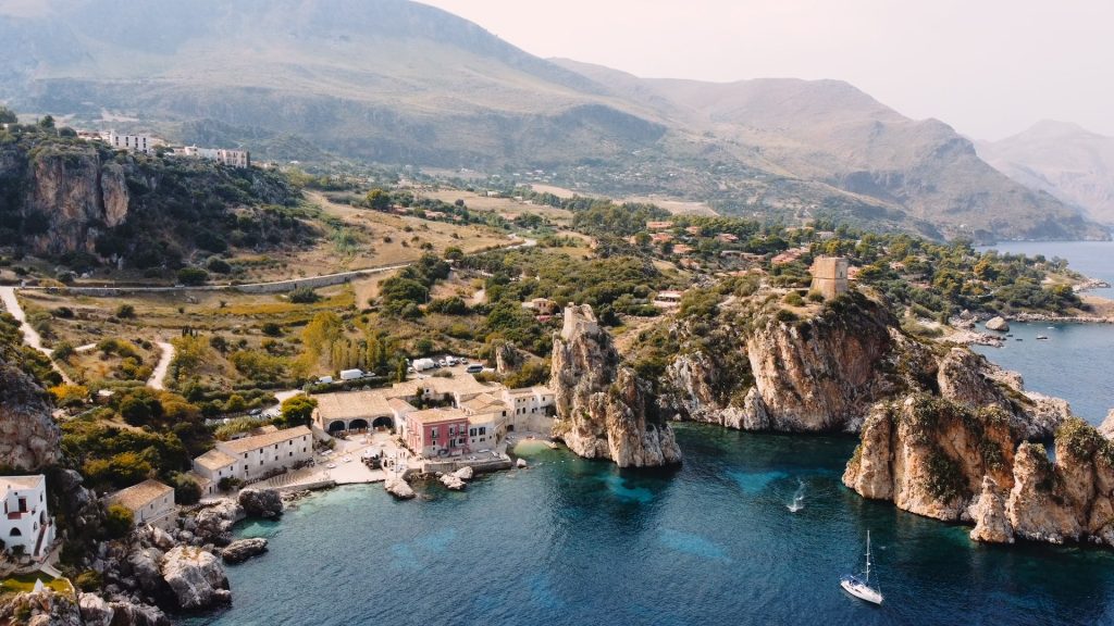 panoramic view of the Tonnara di Scopello along the rocky coast and turquoise sea of Castellamare del Golfo Siciliy