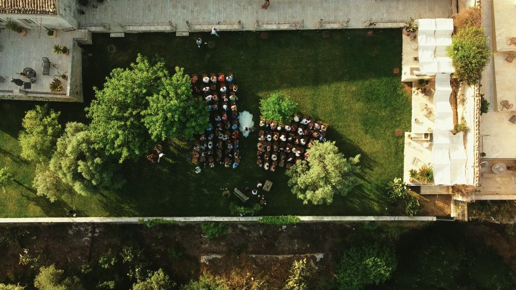 panoramic view from above during the bride's entry of the garden of the ancient Sicilian residence Dimora delle Balze