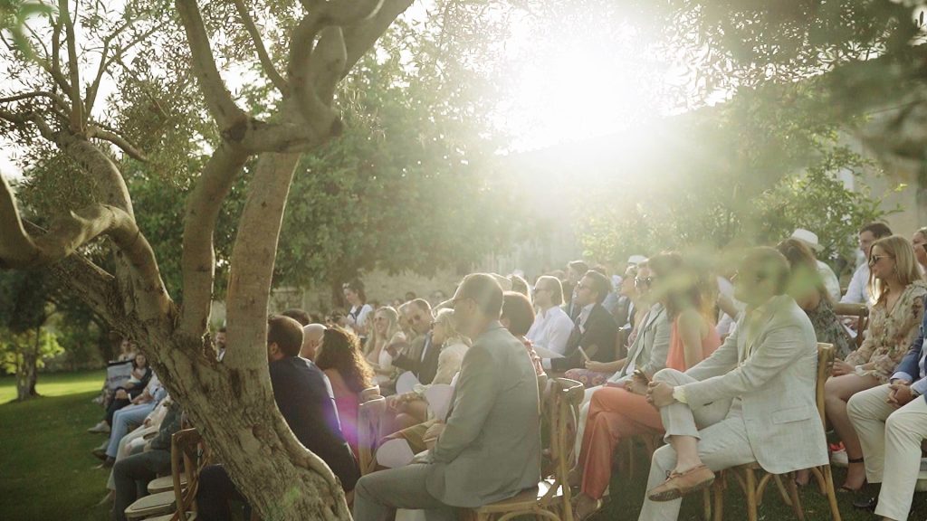 seated guests attending the destination wedding in the garden of the Dimora delle Balze in Sicily at sunset