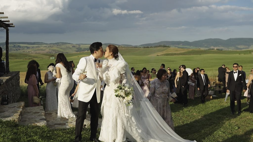 first toast of the newlyweds among the green Tuscan hills