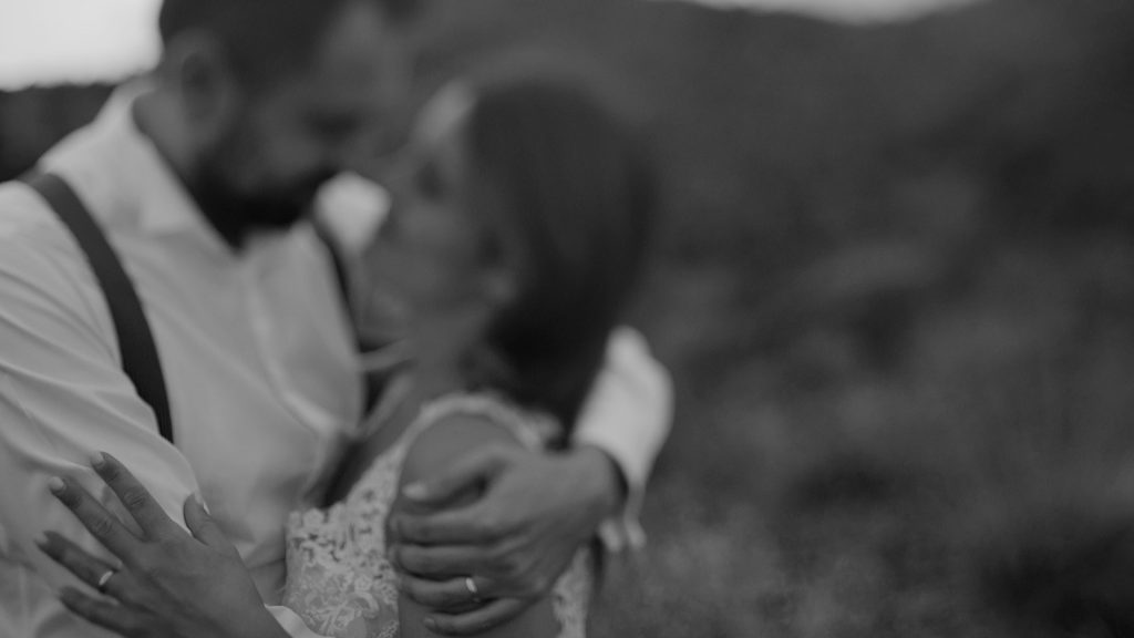 Hug between bride and groom in black and white